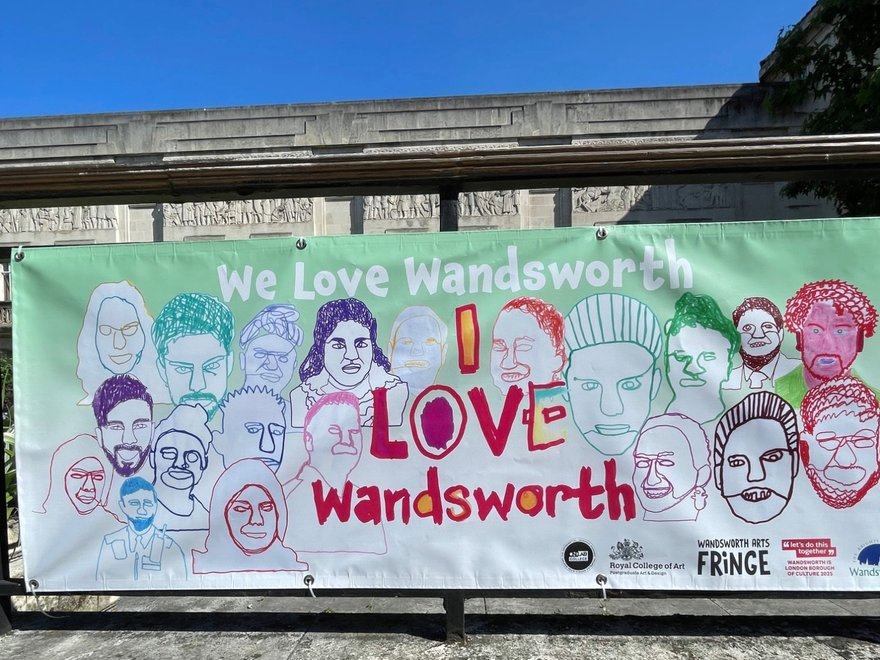 A hand drawn banner is hung outside a municipal building