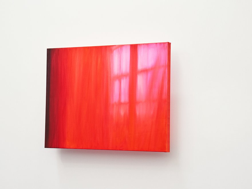 Vibrant red canvas with light from a window outline