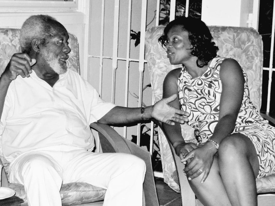 black and white photograph of a man and woman sat down talking