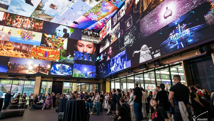 Multiple digital works displayed on an immersive screen at Outernet