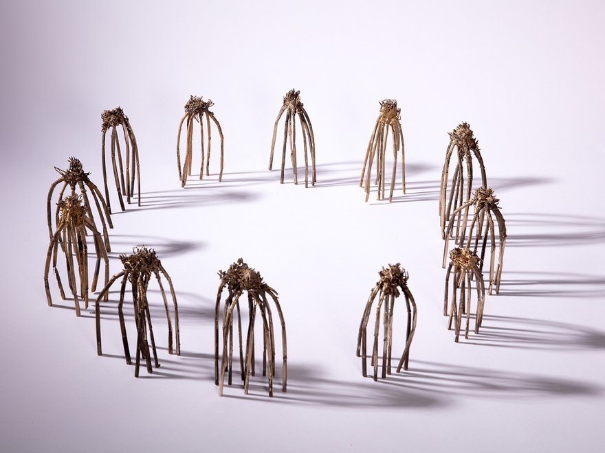 circle of sculptures make from upturned uprooted plants